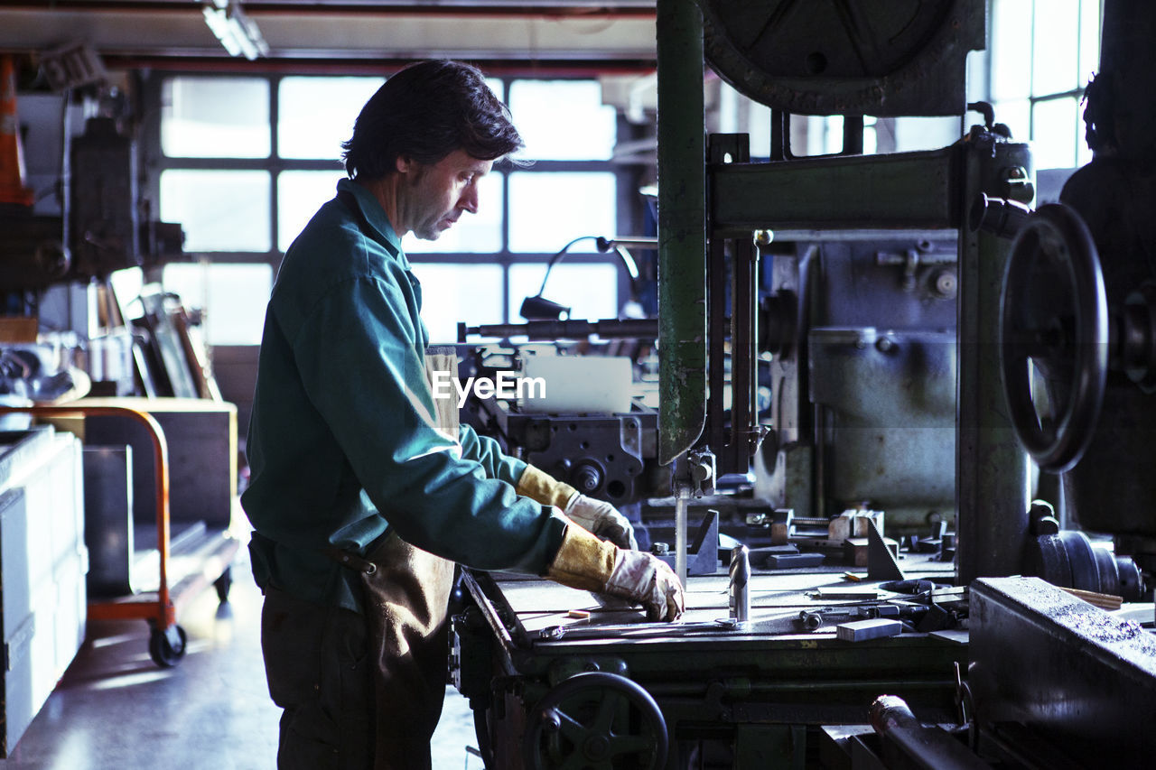 Side view of man working in workshop