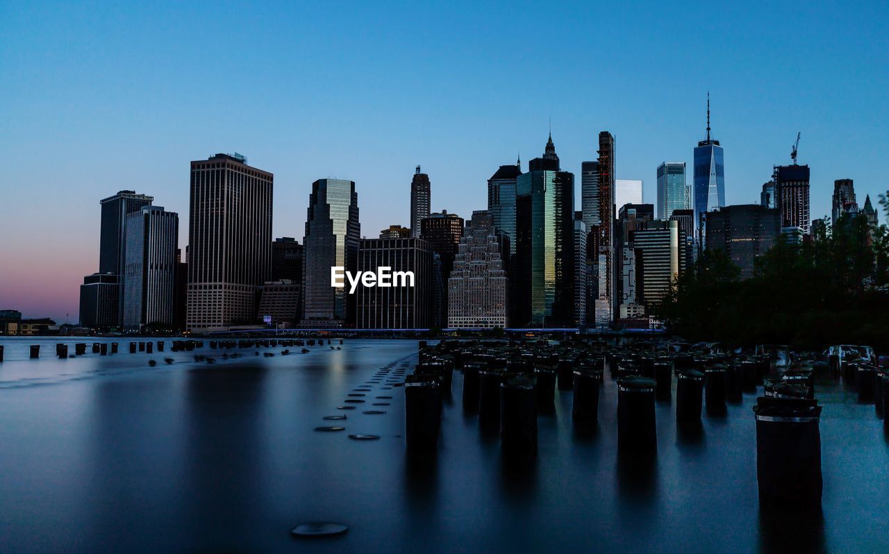 Panoramic view of river and buildings against clear sky