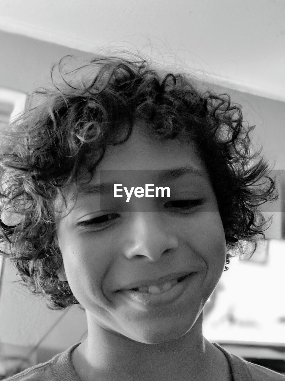 Close-up of smiling boy with curly hair