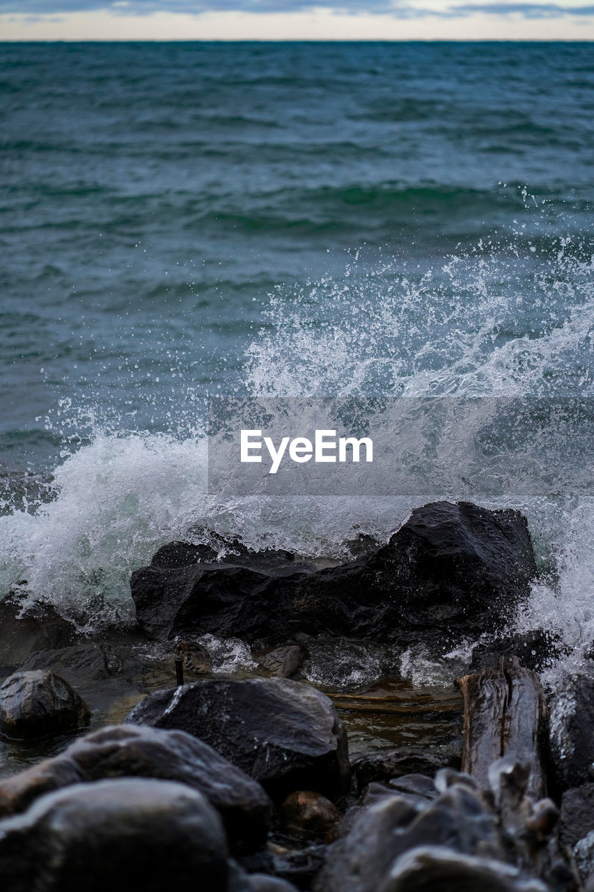 SEA WAVES SPLASHING ON ROCK