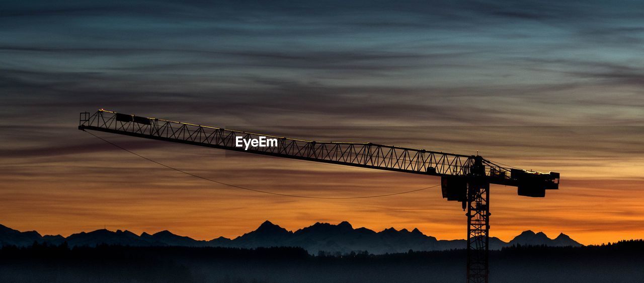 SILHOUETTE BUILT STRUCTURE AGAINST SKY DURING SUNSET