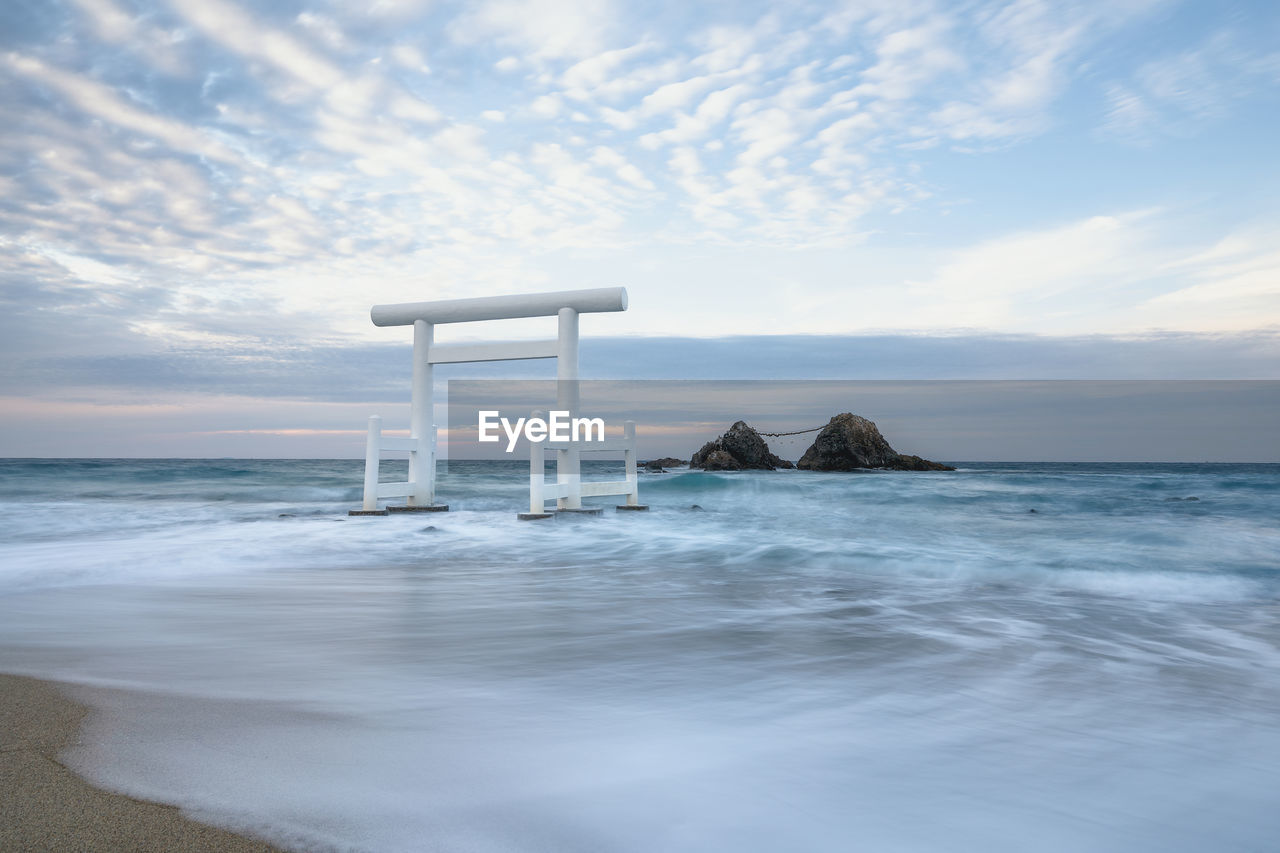 LIFEGUARD HUT ON SEA SHORE AGAINST SKY