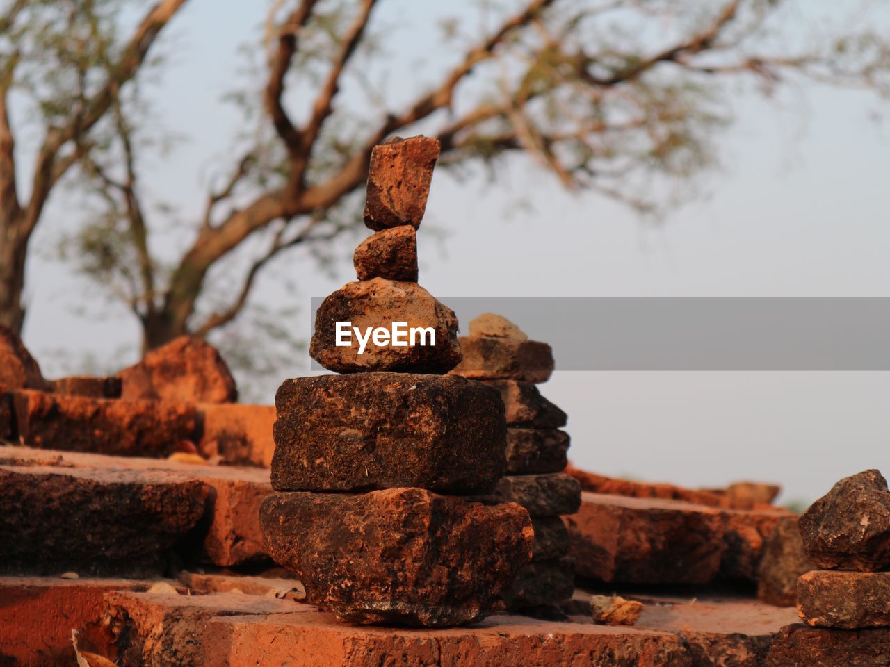 CLOSE-UP OF STACK AGAINST STONE WALL