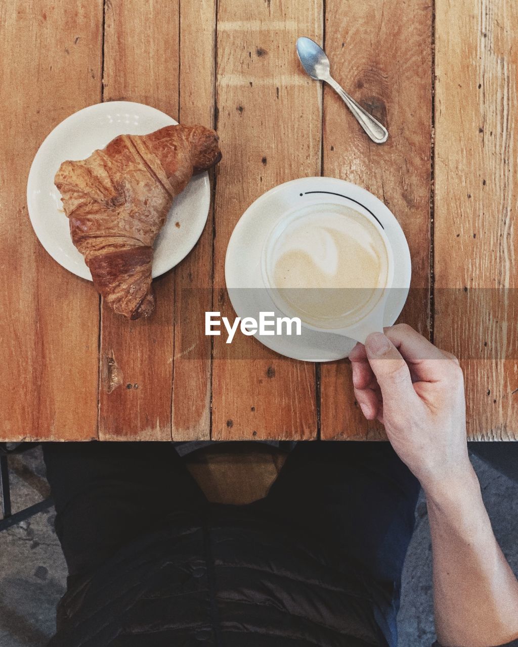 Midsection of man having breakfast on table