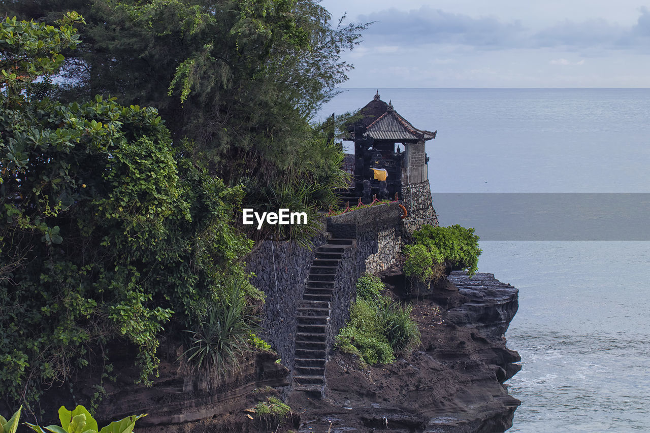 Unique architectural of a temple with a staircase by the cliff in tanah lot, bali