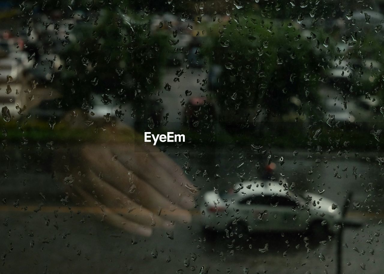 CLOSE-UP OF WATER DROPS ON GLASS WINDOW