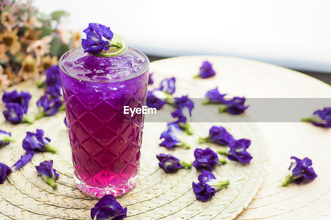 Close-up of purple flower on table