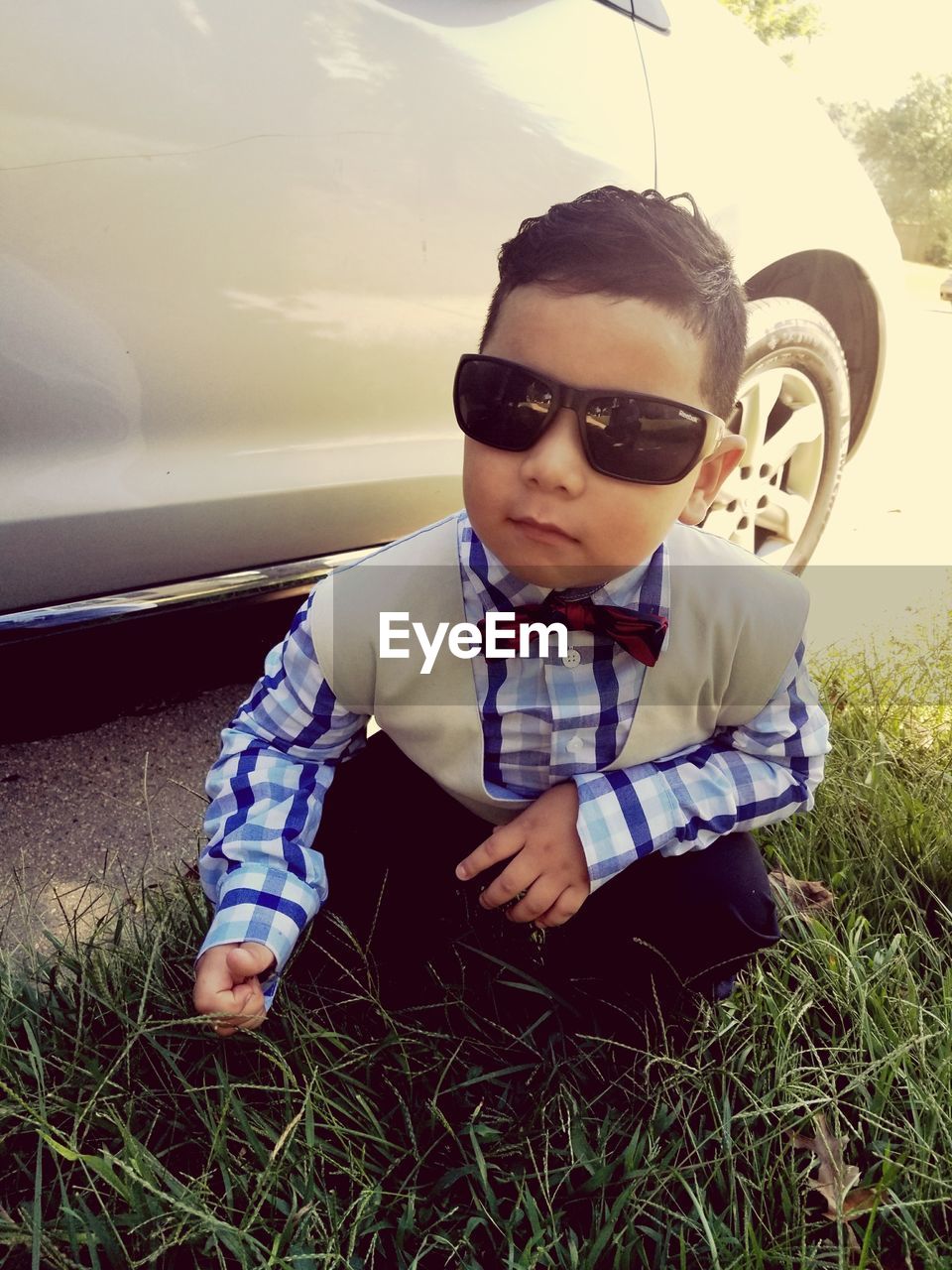 Boy wearing sunglasses on field