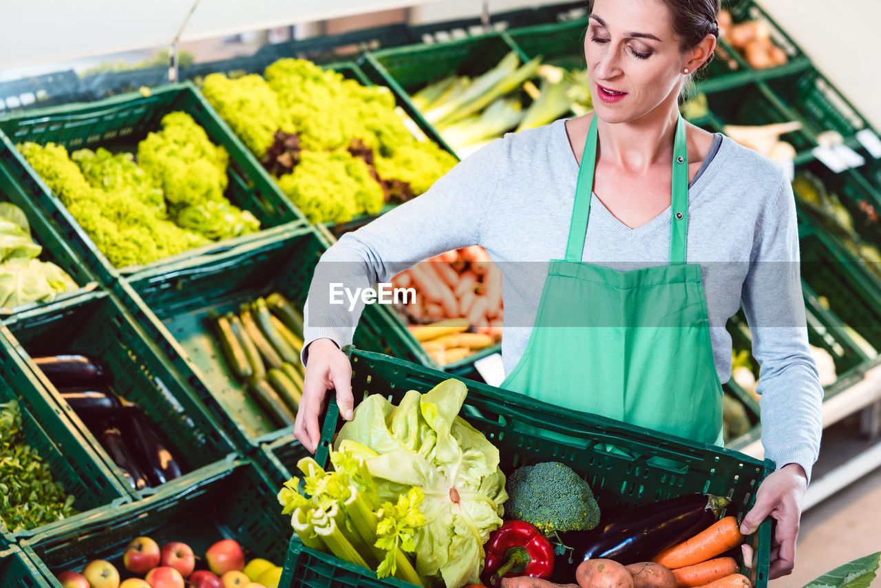 Midsection of woman standing at market stall