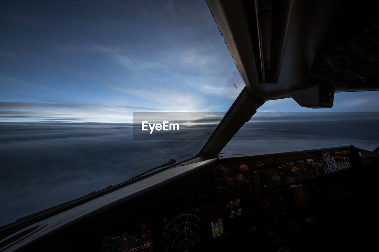 transportation, sky, mode of transportation, airplane, air vehicle, darkness, light, cloud, nature, flying, travel, reflection, motion, screenshot, vehicle interior, horizon, no people, cockpit, aerial view, water, aviation, sea, architecture, aircraft, outdoors, night, aircraft wing, vehicle, scenics - nature, sunset, window, glass, environment, journey