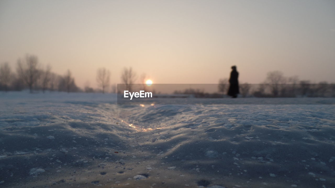 Scenic view of frozen lake against clear sky during winter