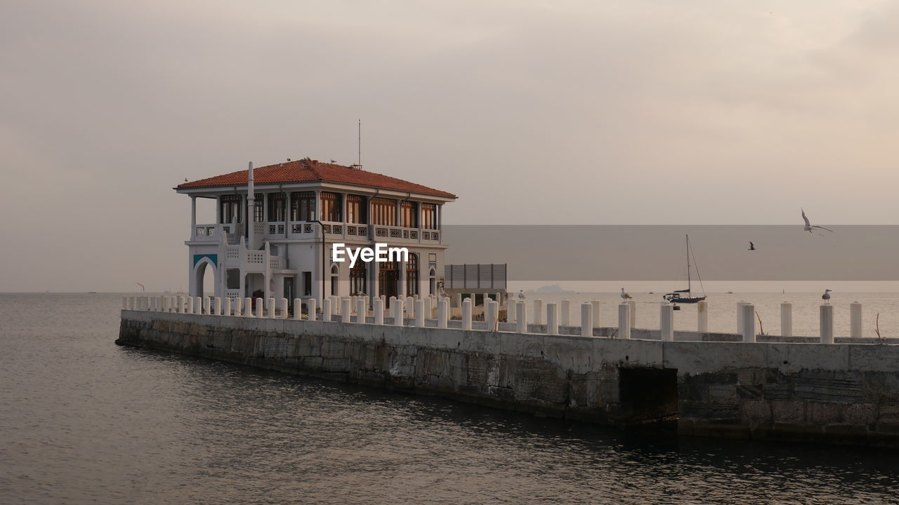 BUILDING AGAINST SKY DURING SUNSET