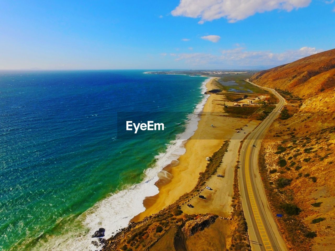 Aerial view of sea against sky on sunny day