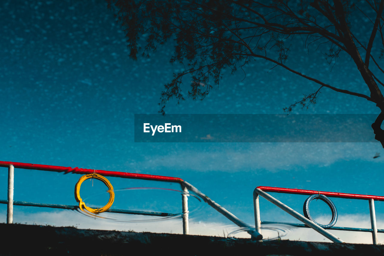 Low angle view of swimming pool against blue sky