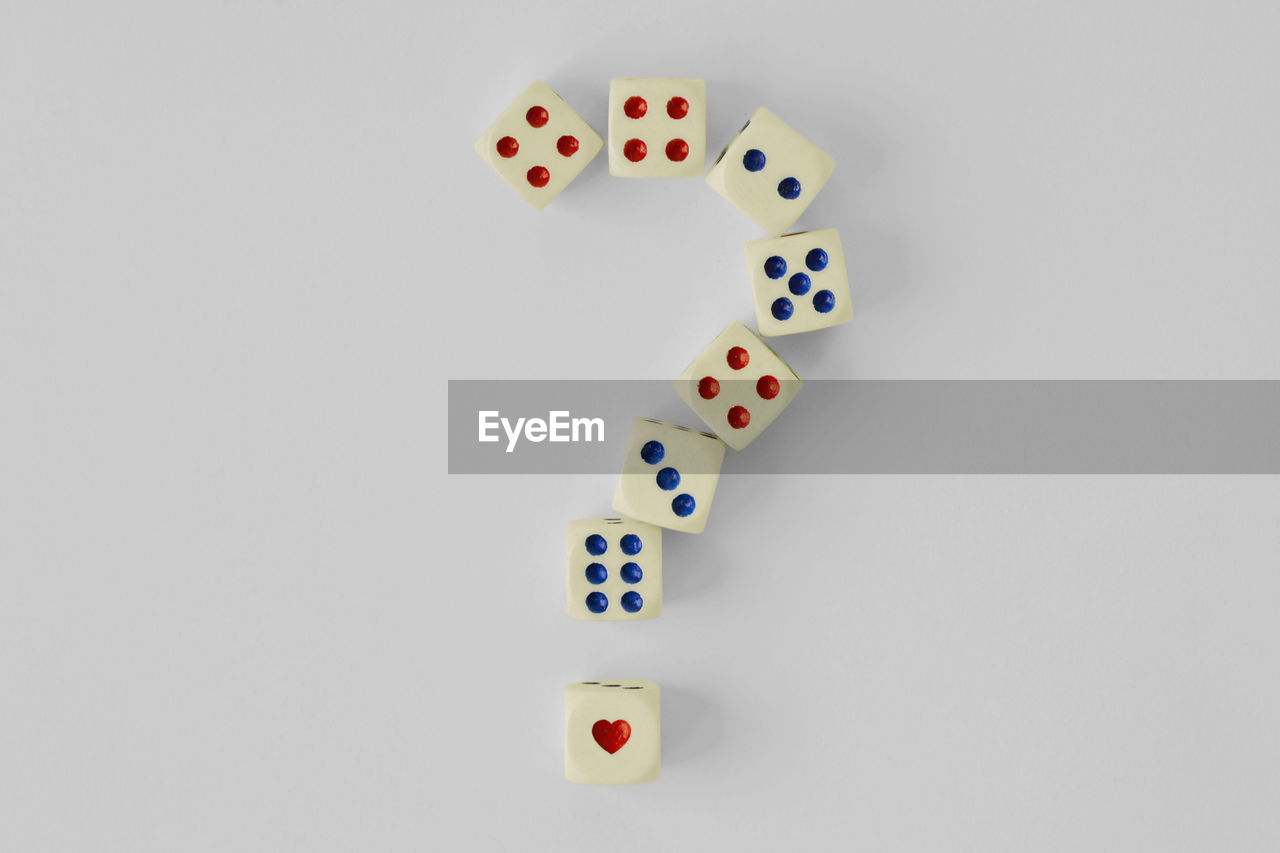 Dices forming question mark over white background