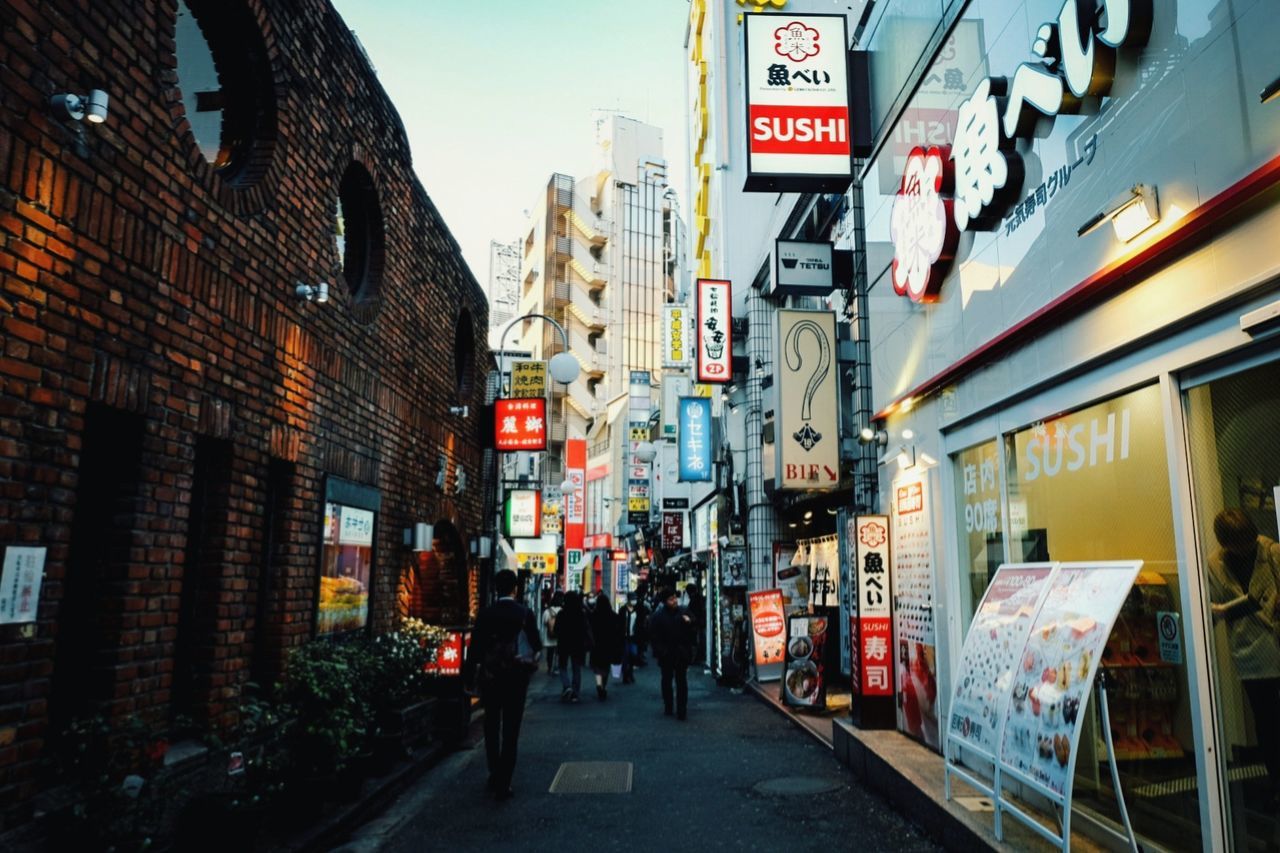 PEOPLE WALKING ON STREET IN CITY