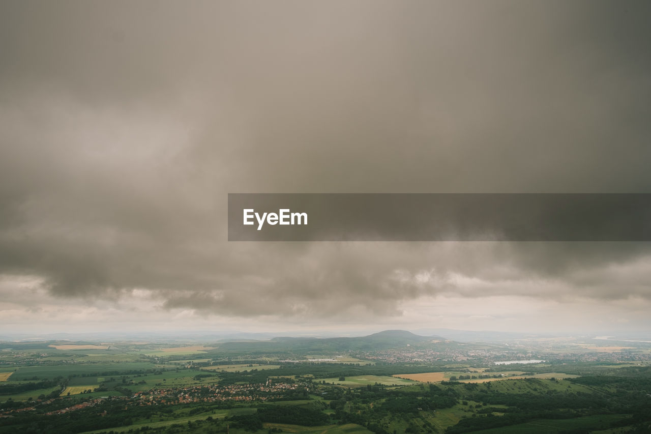 SCENIC VIEW OF STORM CLOUDS OVER LANDSCAPE AGAINST SKY