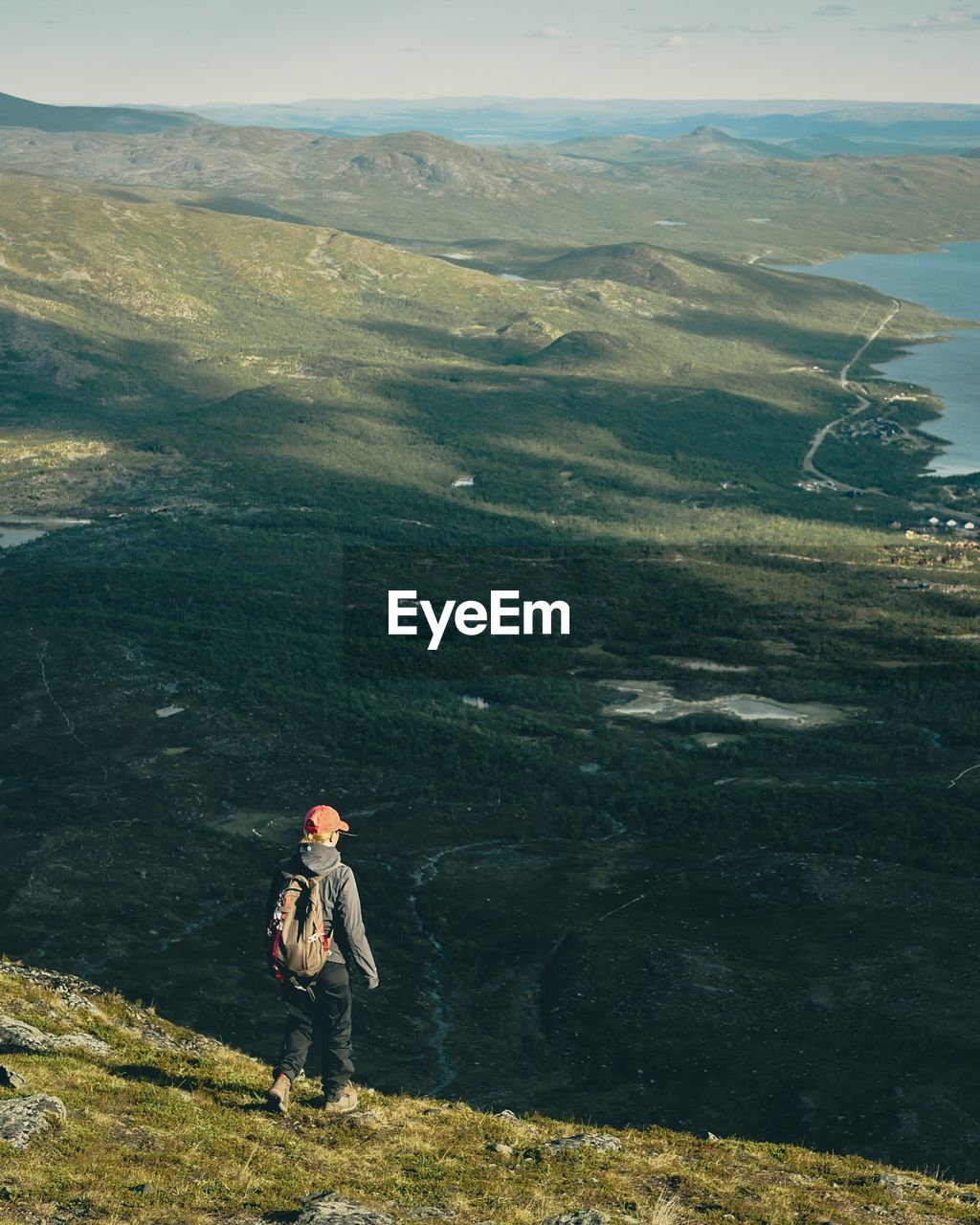 Rear view of woman with backpack walking on mountain