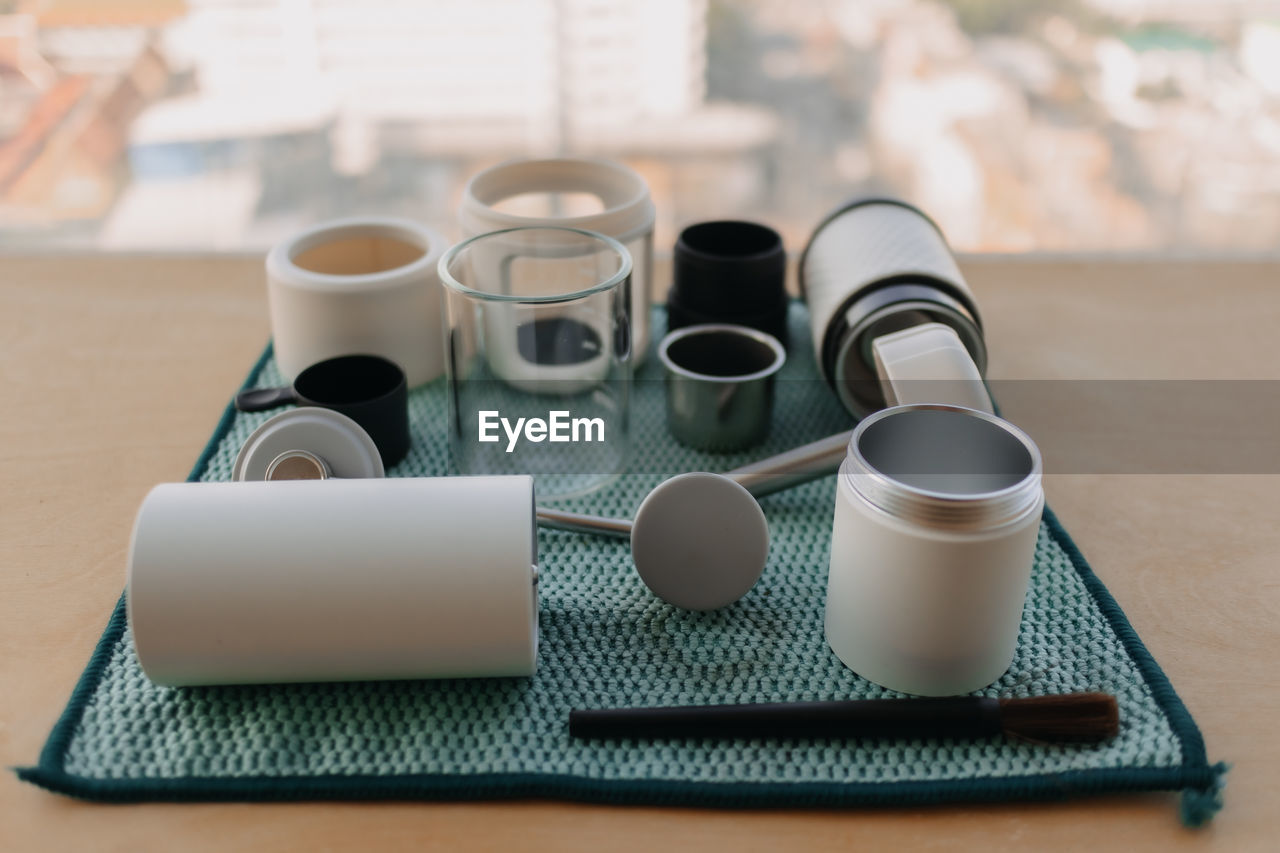 cup, indoors, mug, coffee cup, table, drink, coffee, food and drink, no people, tableware, still life, wireless technology, ceramic, furniture, business, refreshment, crockery, home interior, technology, household equipment, focus on foreground