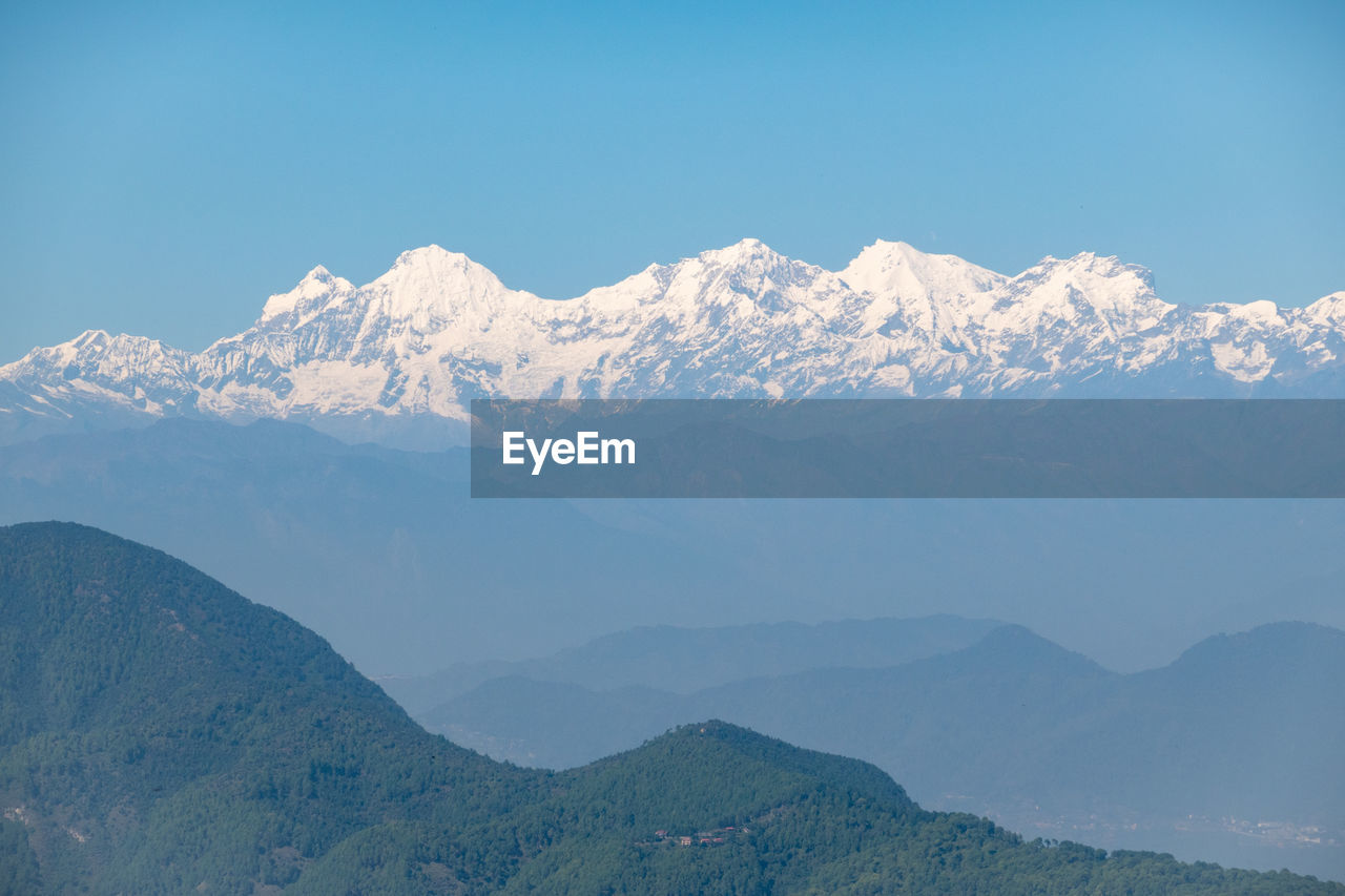 Scenic view of snowcapped mountains against clear sky