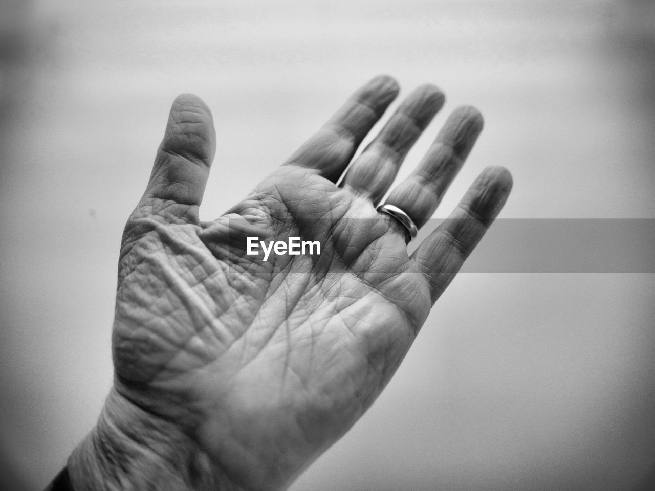 Close-up of wrinkled hand against white background