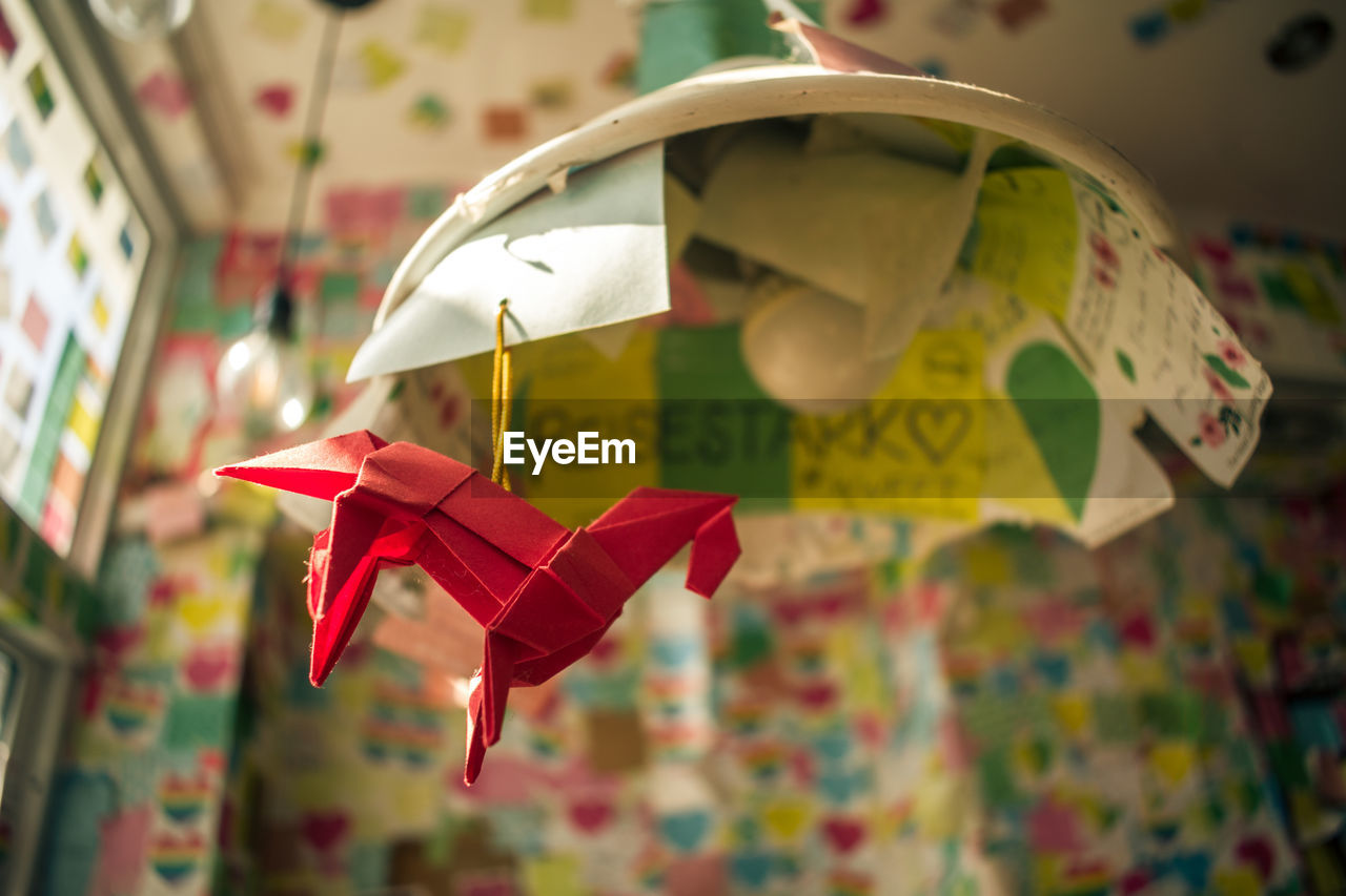 CLOSE-UP OF PAPER TOY HANGING ON CLOTHESLINE