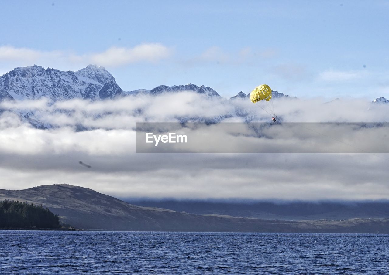 Scenic view of lake and mountains against sky