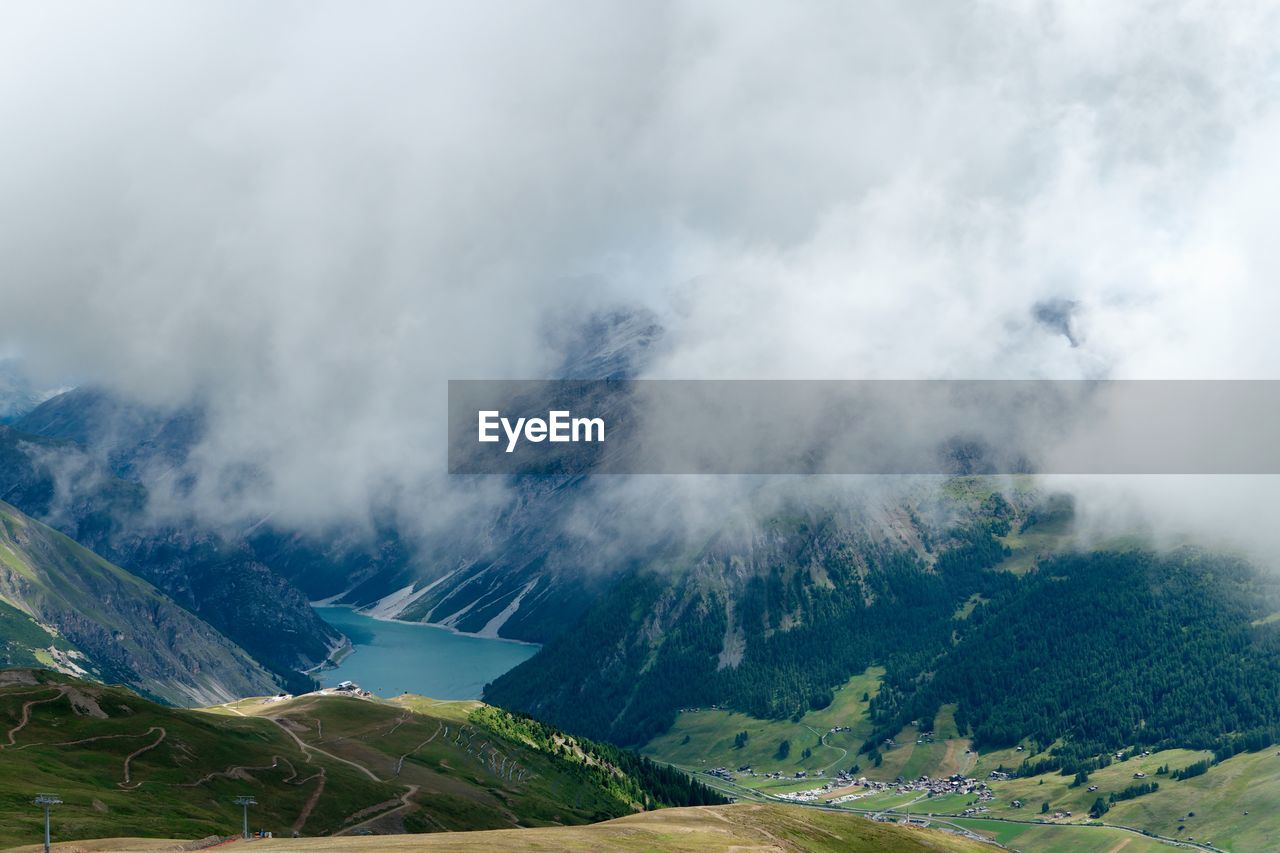 SCENIC VIEW OF TREES ON MOUNTAIN AGAINST SKY