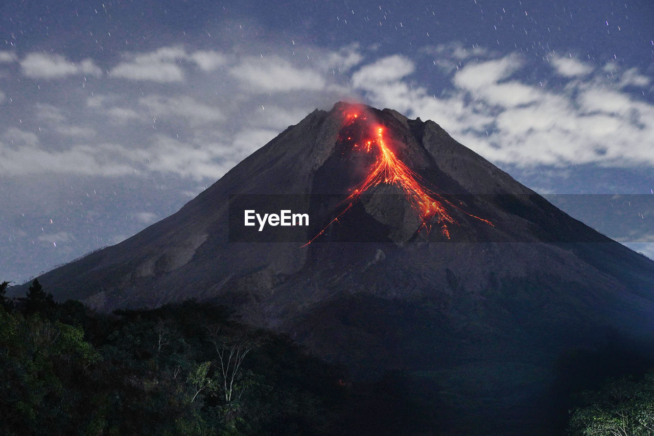 View of illuminated volcanic mountain against sky