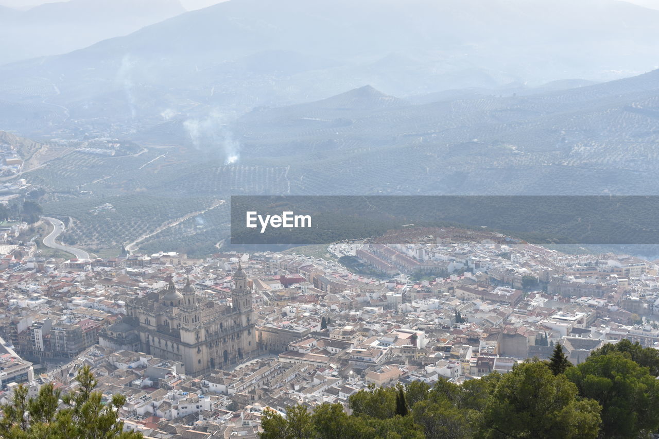 Aerial view of historic building amidst cityscape during sunny day