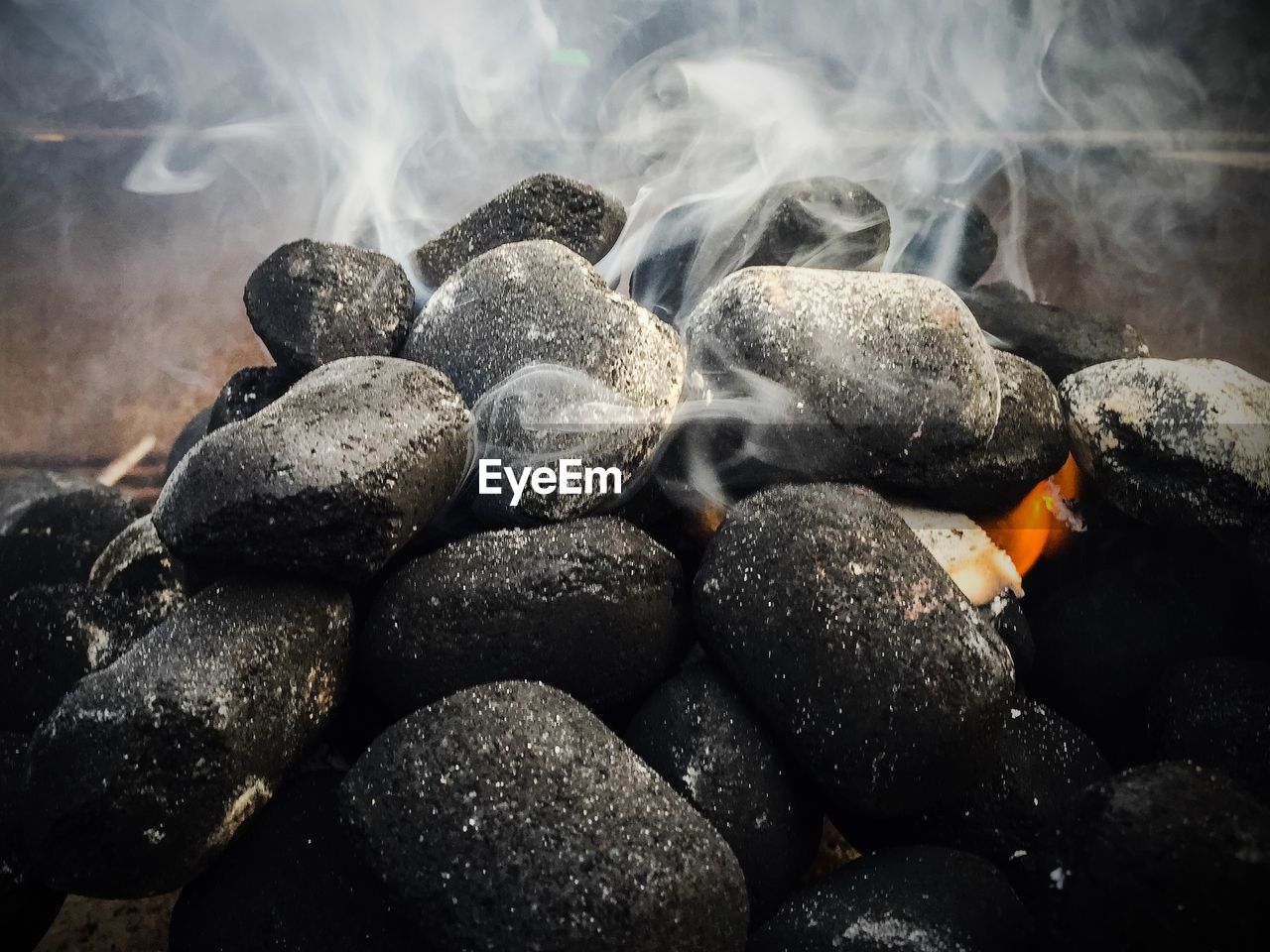 Close-up of smoke emitting from coals