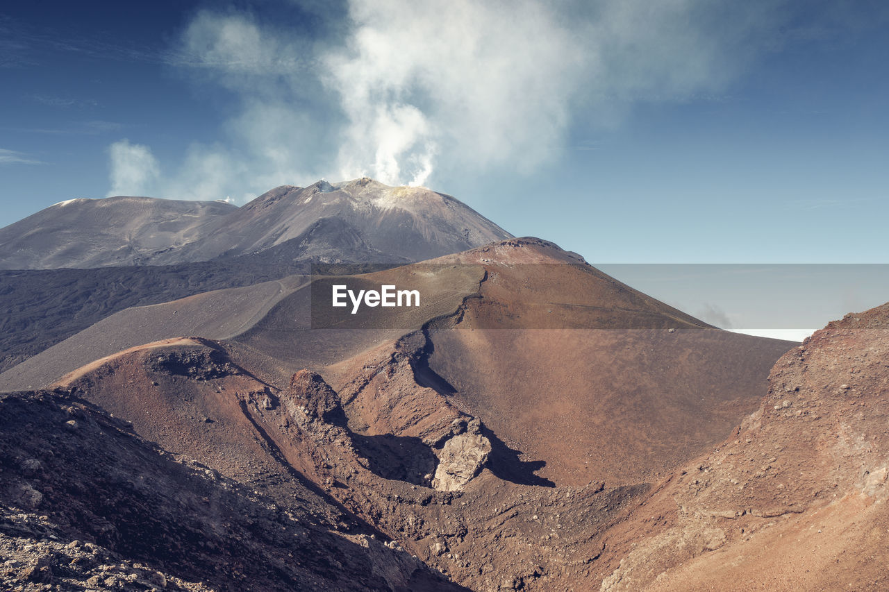 Scenic view of volcanic mountain against sky