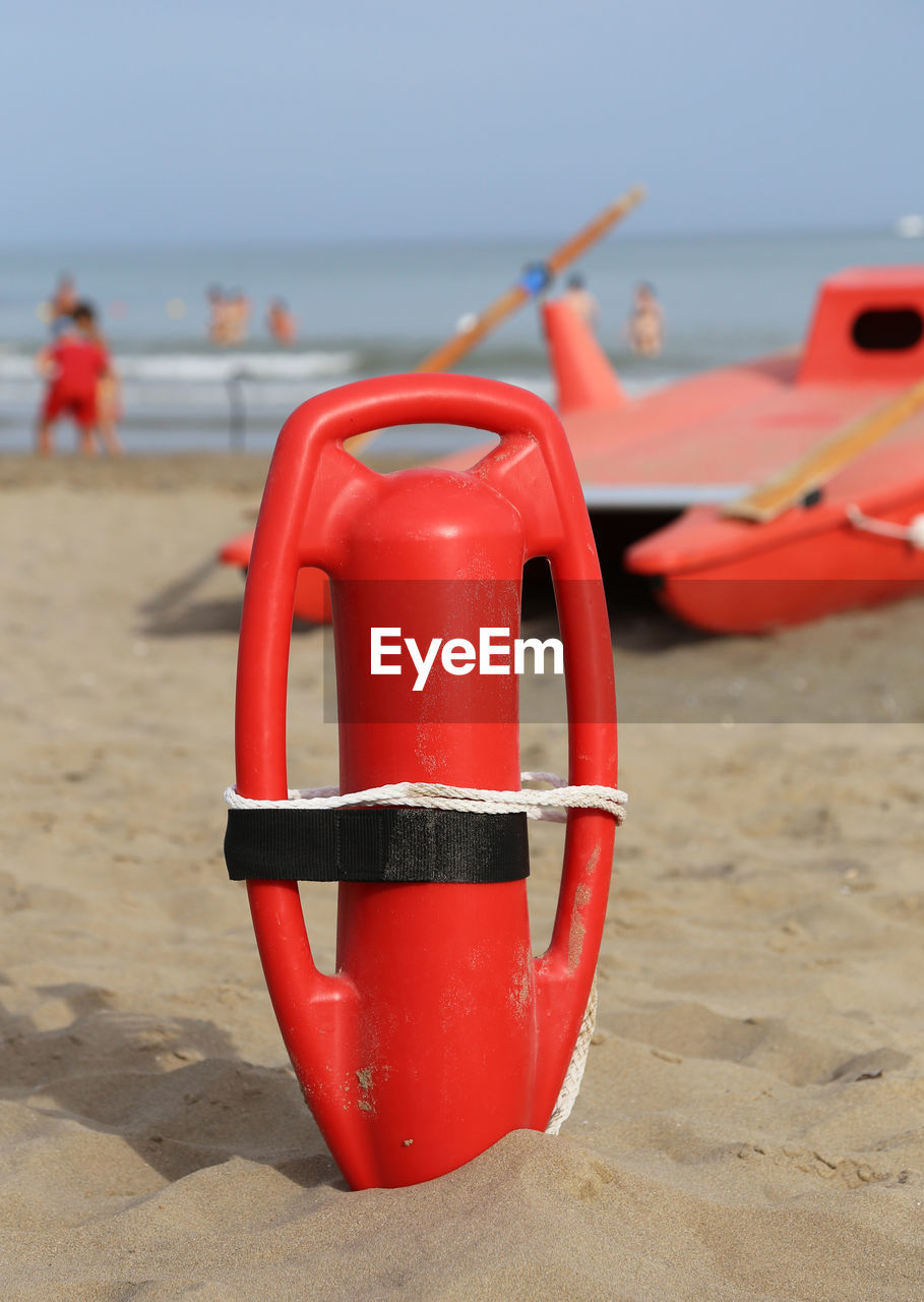 RED TOY ON BEACH