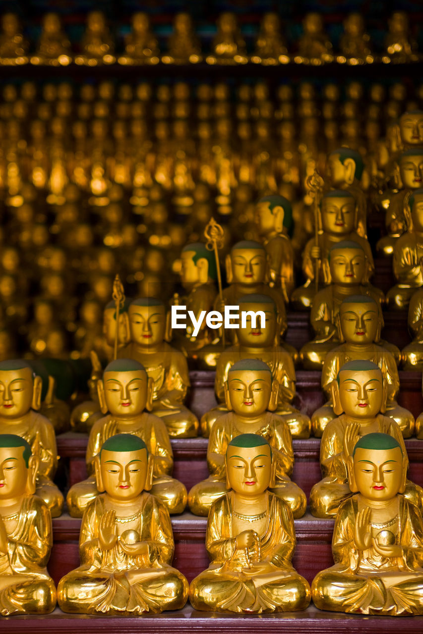 Golden buddha statues at a buddhist temple