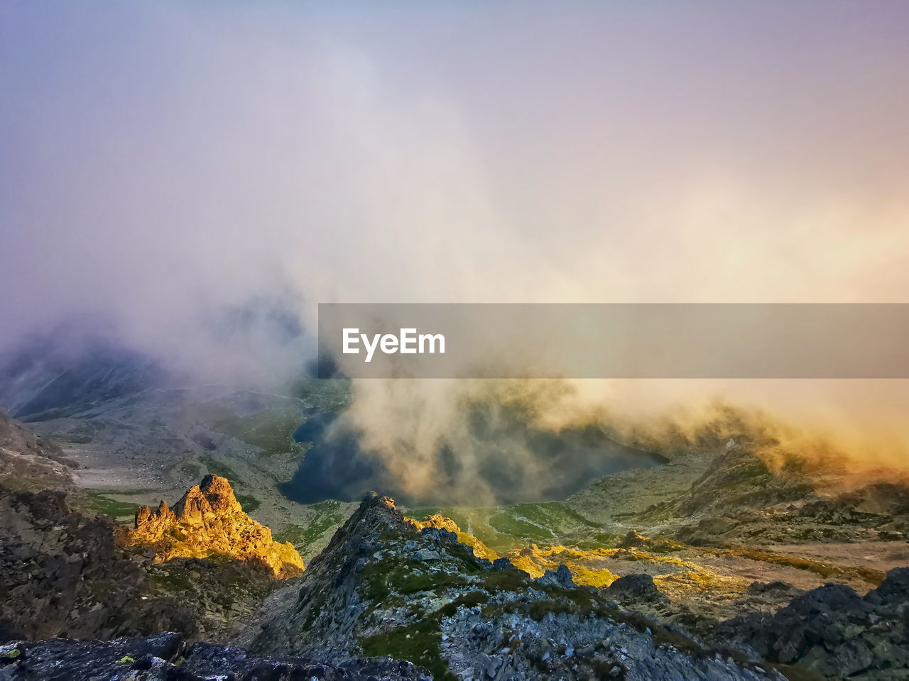 Mountain valley in the clouds lit by the setting sun. tatra mountains slovakia.