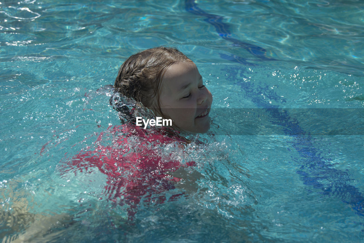 High angle view of girl swimming in pool