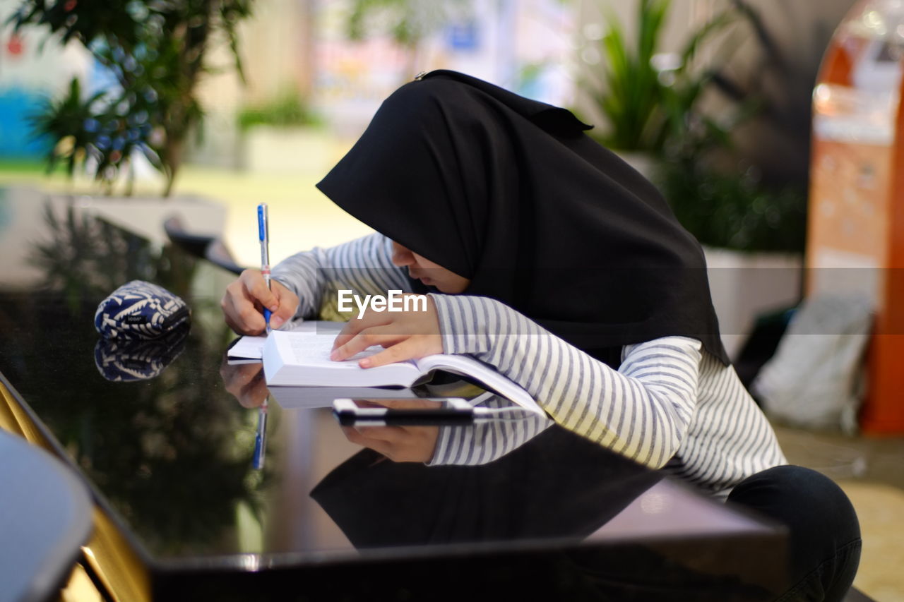 Close-up of woman studying