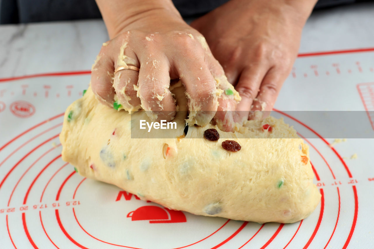 Home pastry chef kneading of the dough for making artisan fruit bread or panettone