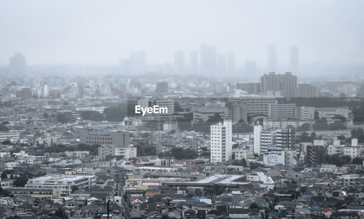 High angle view of buildings in city against sky