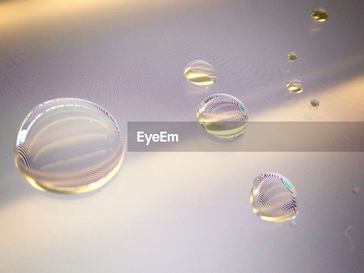 Close-up of water drops on digital tablet screen