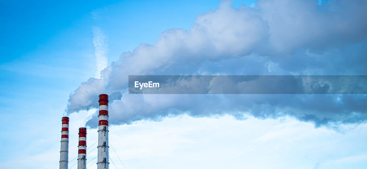 sky, cloud, tower, blue, nature, day, environment, industry, outdoors, technology, built structure, architecture, no people, copy space, communication, power generation, low angle view