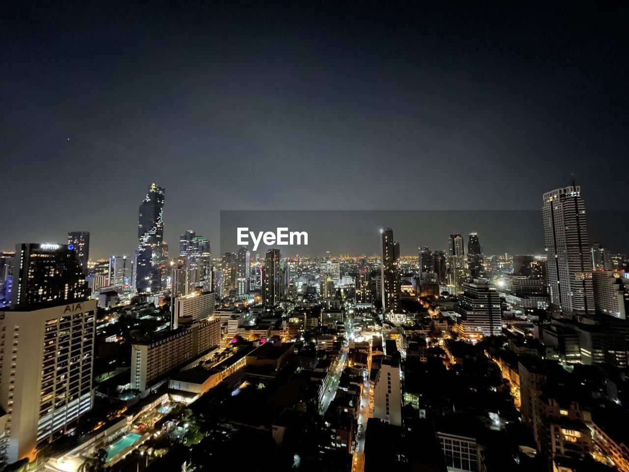 Illuminated cityscape against sky at night