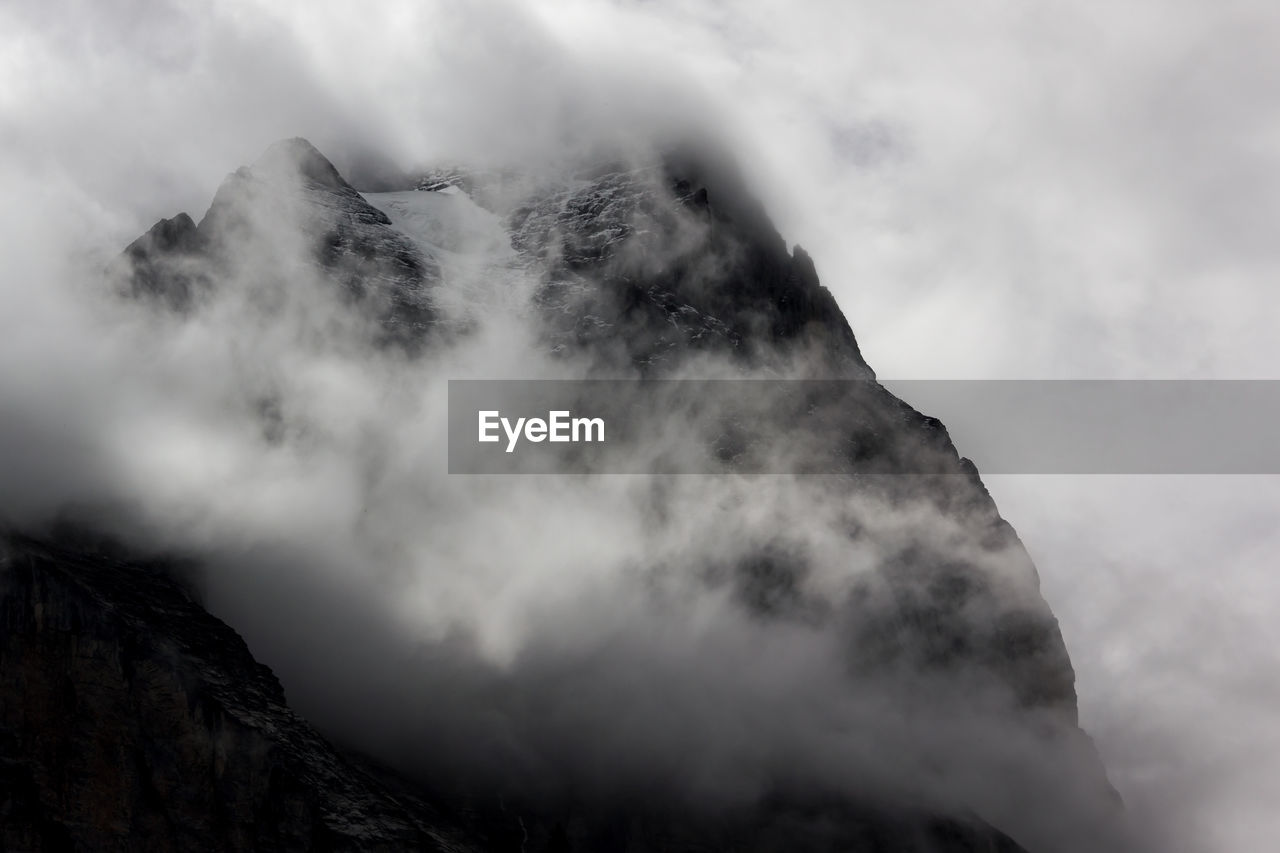 Scenic view of mountains against cloudy sky