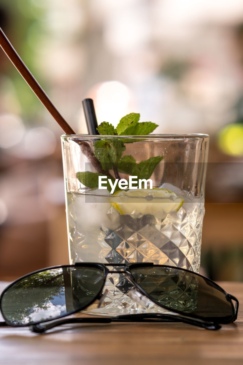 CLOSE-UP OF BEER GLASS WITH DRINK ON TABLE