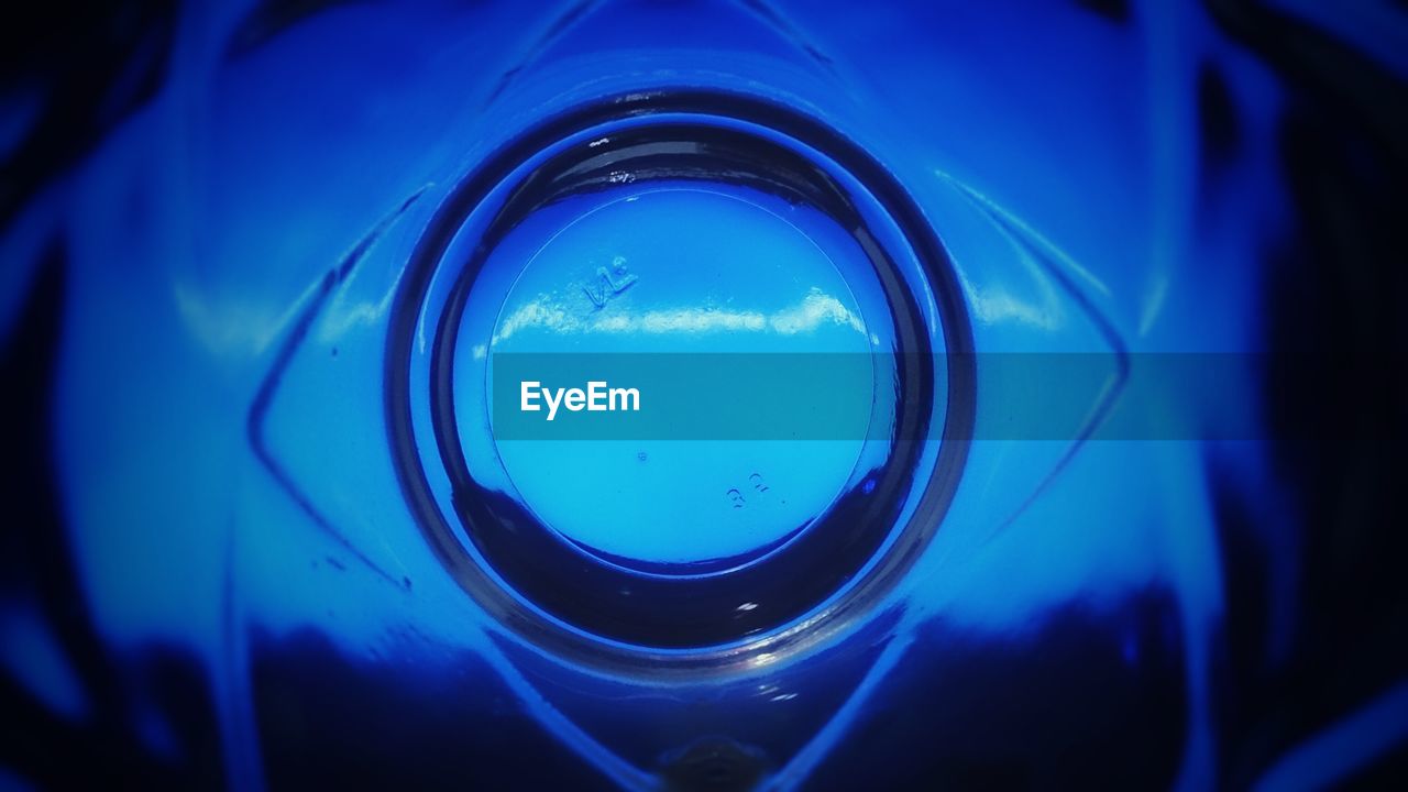 CLOSE-UP OF WATER DROPS ON BLUE BACKGROUND