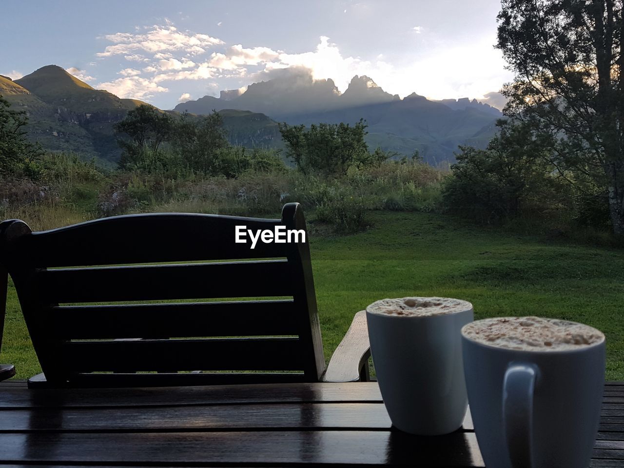 EMPTY TABLE AGAINST MOUNTAIN RANGE AND SKY