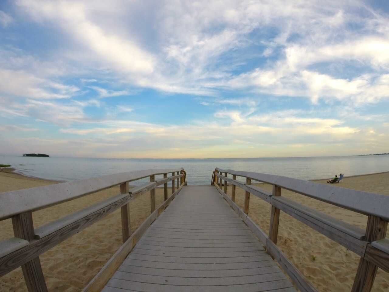 Empty boardwalk leading onto sandy beach