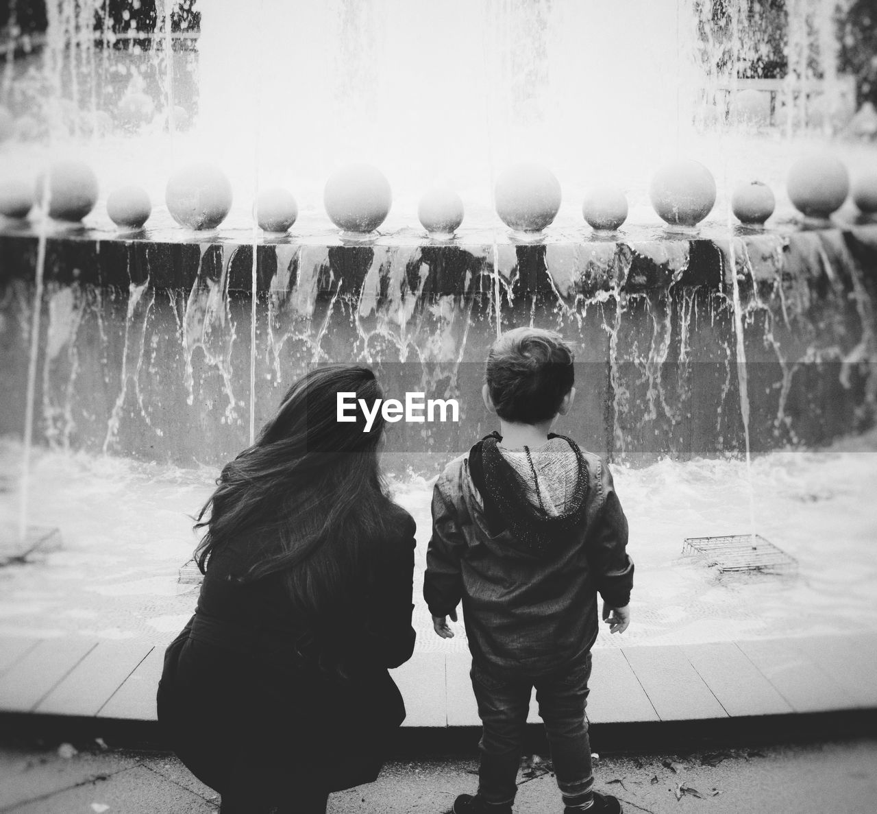 REAR VIEW OF BOY WITH WATER