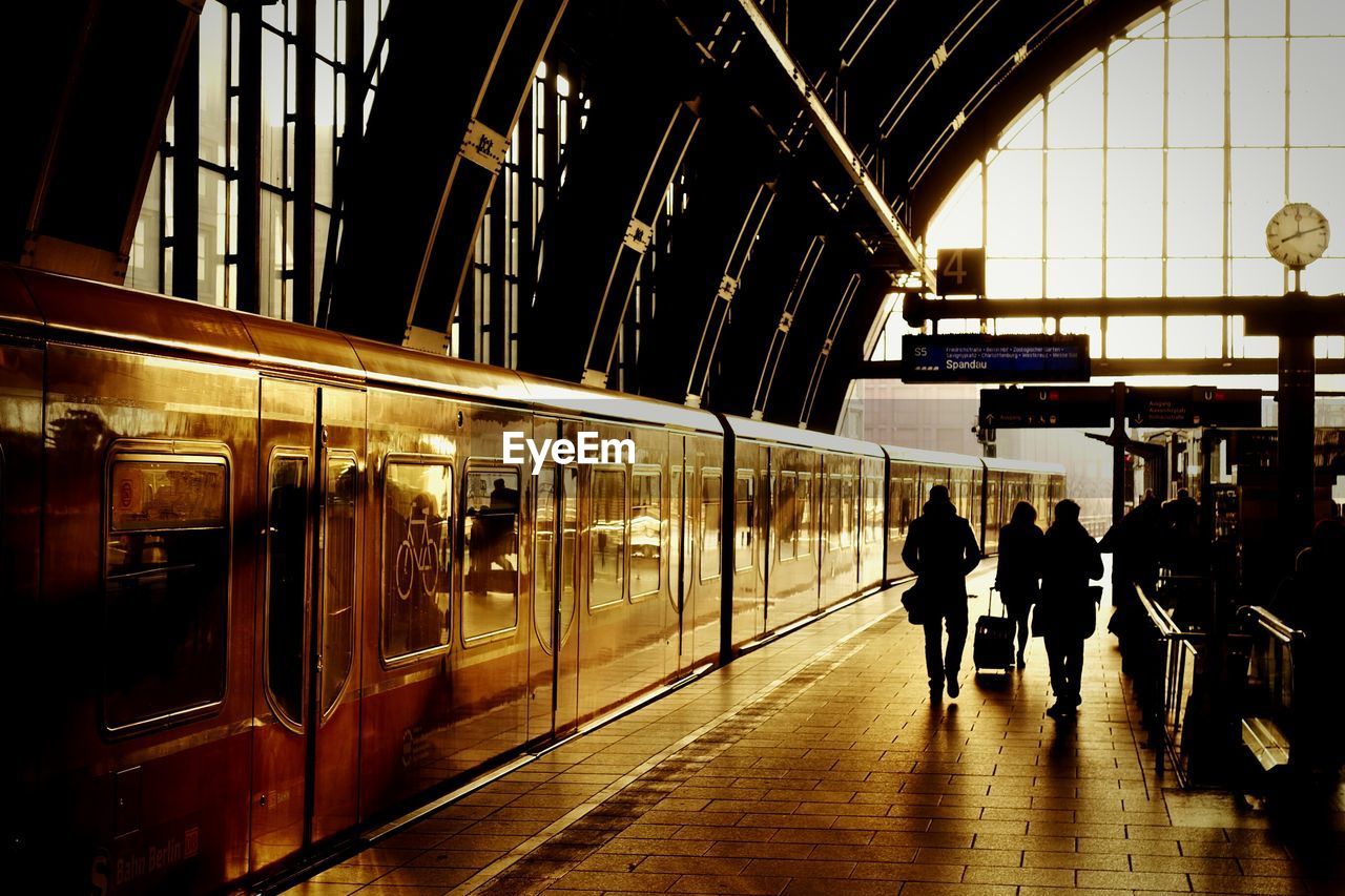 People walking by train at subway station