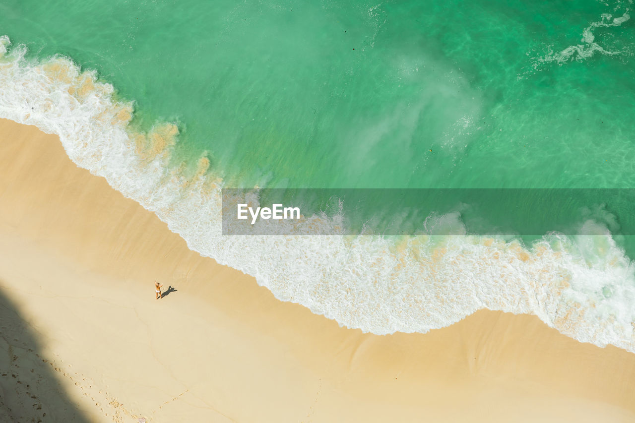 Aerial view of woman standing on beach